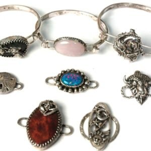 Vintage silver jewelry collection with bracelets and ornate pendants