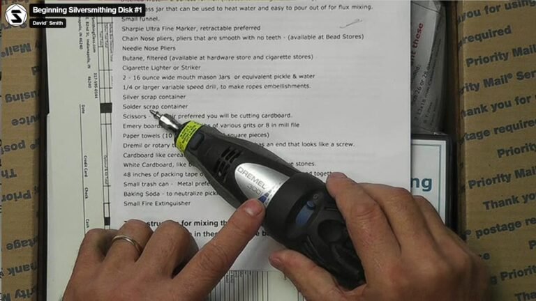 Dremel rotary tool on silversmithing workbench with polishing wheel attached