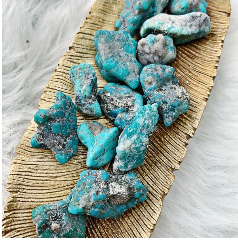 Raw turquoise nugget showing sky blue color with brown matrix veining