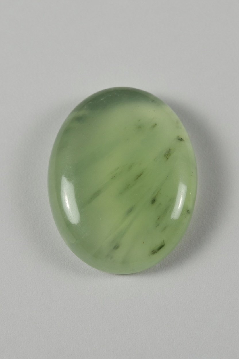 Polished Prehnite cabochon with soft green translucency
